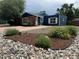 Inviting front yard featuring decorative rock, vibrant flowers, and lush greenery, enhancing curb appeal at 10130 W 20Th Ave, Lakewood, CO 80215