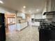Spacious kitchen featuring white cabinets, sleek appliances, and a stylish eat-in counter at 10130 W 20Th Ave, Lakewood, CO 80215