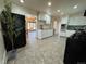 Bright and open kitchen with stainless appliances, tiled floors, and access to other rooms at 10130 W 20Th Ave, Lakewood, CO 80215