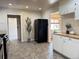 Spacious kitchen with views to other rooms features a large refrigerator and stylish flooring at 10130 W 20Th Ave, Lakewood, CO 80215