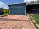 Exterior view of a patio with a brick border and stone pavers leading to the house at 10130 W 20Th Ave, Lakewood, CO 80215
