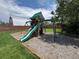 Backyard playground featuring swings, a slide, and climbing structure on a mulch base at 10130 W 20Th Ave, Lakewood, CO 80215