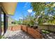 Private back patio with brick half wall, fenced yard, and natural landscaping at 1011 Pierce St # 11, Lakewood, CO 80214