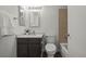 Well-lit bathroom with framed mirror, tiled backsplash, granite countertop, and combination tub/shower at 1011 Pierce St # 11, Lakewood, CO 80214