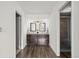 This luxurious bathroom features a double vanity, wood floors, and a frameless glass shower enclosure at 1011 Pierce St # 11, Lakewood, CO 80214