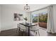 Well-lit dining room with marble table, modern chairs, and sliding glass doors to the patio at 1011 Pierce St # 11, Lakewood, CO 80214