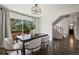 Bright dining room features a modern light fixture, sliding glass doors, and sleek dark wood floors at 1011 Pierce St # 11, Lakewood, CO 80214