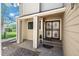 Home entrance with decorative security door, small porch, and tan siding at 1011 Pierce St # 11, Lakewood, CO 80214