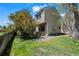 Exterior view of home featuring a private backyard, established trees and fresh green grass at 1011 Pierce St # 11, Lakewood, CO 80214
