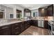 Kitchen with granite countertops, dark cabinets, and stainless steel appliances at 1011 Pierce St # 11, Lakewood, CO 80214