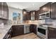 Beautiful kitchen with granite countertops, dark cabinets and stainless steel appliances at 1011 Pierce St # 11, Lakewood, CO 80214