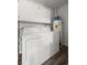 Bright and functional laundry room with front load washer and dryer, storage cabinets, and laminate flooring at 1011 Pierce St # 11, Lakewood, CO 80214