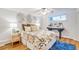 Spacious bedroom with wood floors, ceiling fan, and decorative wall art at 10 N Ogden St # 5, Denver, CO 80218