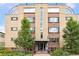 Exterior building view showing brick facade, many windows, and landscaped grounds at 10 N Ogden St # 5, Denver, CO 80218