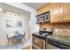 Modern kitchen featuring stainless steel appliances and wood cabinets at 10 N Ogden St # 5, Denver, CO 80218