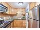 Bright kitchen boasts light wood cabinets, granite countertops, and stainless steel appliances at 10 N Ogden St # 5, Denver, CO 80218