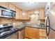 Cozy kitchen featuring light wood cabinets, granite countertops, and stainless steel appliances at 10 N Ogden St # 5, Denver, CO 80218