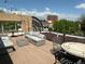 Relaxing rooftop deck with comfortable seating and city views, perfect for entertaining or enjoying the outdoors at 10 N Ogden St # 5, Denver, CO 80218