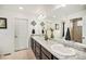 Bathroom featuring double sinks with granite countertops and a large mirror at 5325 Ventura St, Denver, CO 80249