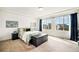 Sun-lit bedroom with a large window, tray ceiling, and a comfortable bed with stylish decor at 5325 Ventura St, Denver, CO 80249
