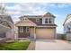 Charming two-story home featuring a two-car garage and manicured lawn at 5325 Ventura St, Denver, CO 80249