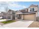 Well-maintained front yard with modern landscaping and a wide driveway leading to a two-car garage at 5325 Ventura St, Denver, CO 80249