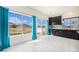 Bright kitchen with dark cabinets, granite countertops, and a view of the backyard at 5325 Ventura St, Denver, CO 80249