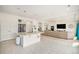 Open-concept kitchen featuring stainless steel appliances, and a large island with view into the living room at 5325 Ventura St, Denver, CO 80249