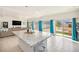 Bright, open kitchen featuring a large island with granite countertop and view into the adjacent living room at 5325 Ventura St, Denver, CO 80249