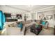 Bright and open living room with modern lighting and seamless access to the kitchen at 5325 Ventura St, Denver, CO 80249