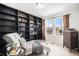 Cozy sitting room with built-in shelving and natural light from the windows at 5325 Ventura St, Denver, CO 80249