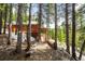 Charming wood cabin with a spacious deck and a bridge leading to the backyard at 489 Harris Dr, Idaho Springs, CO 80452