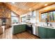 Open concept kitchen with a stone fireplace and wood-paneled ceiling creating a cozy, mountain home atmosphere at 489 Harris Dr, Idaho Springs, CO 80452