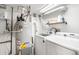 Functional laundry room with washer, dryer, and storage shelf at 489 Harris Dr, Idaho Springs, CO 80452