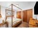 Primary bedroom with a four-poster bed and natural wood accents, creating a peaceful and rustic ambiance at 489 Harris Dr, Idaho Springs, CO 80452