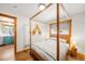 Bedroom with a view to the kitchen and natural wood accents, creating a warm and rustic ambiance at 489 Harris Dr, Idaho Springs, CO 80452