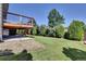 Large backyard featuring a wooden deck and lush lawn at 15941 Bluebonnet Dr, Parker, CO 80134