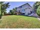 Large backyard with wooden deck, green lawn, and mature trees at 15941 Bluebonnet Dr, Parker, CO 80134