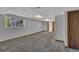 Finished basement with neutral carpet, drop ceiling with lights, and access to backyard at 15941 Bluebonnet Dr, Parker, CO 80134