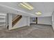 Spacious carpeted basement with drop ceiling, stairs and storage at 15941 Bluebonnet Dr, Parker, CO 80134