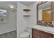 Stylish half bath with a dark vanity and modern mirror, offering an efficient use of space at 15941 Bluebonnet Dr, Parker, CO 80134
