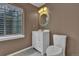 Bathroom featuring white vanity, granite countertops, and an oval mirror at 15941 Bluebonnet Dr, Parker, CO 80134