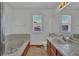 Bright bathroom featuring a bathtub, sink and large mirror at 15941 Bluebonnet Dr, Parker, CO 80134