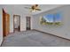 Bedroom with neutral carpet, ceiling fan, and large window with a scenic view at 15941 Bluebonnet Dr, Parker, CO 80134