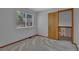 A bright bedroom leading into a hallway with wood trim and neutral colored walls at 15941 Bluebonnet Dr, Parker, CO 80134