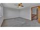 Bedroom featuring neutral carpet and staircase to the upper level at 15941 Bluebonnet Dr, Parker, CO 80134