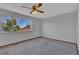 Bright bedroom featuring a ceiling fan and scenic window views at 15941 Bluebonnet Dr, Parker, CO 80134