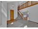 Welcoming foyer with staircase, wood accents, and an open view to the second story landing at 15941 Bluebonnet Dr, Parker, CO 80134