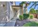 Close-up view of front entrance featuring a decorative glass door and manicured landscaping at 15941 Bluebonnet Dr, Parker, CO 80134