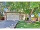 Inviting front exterior of home showcasing mature landscaping, brick accents, and a two-car garage at 15941 Bluebonnet Dr, Parker, CO 80134